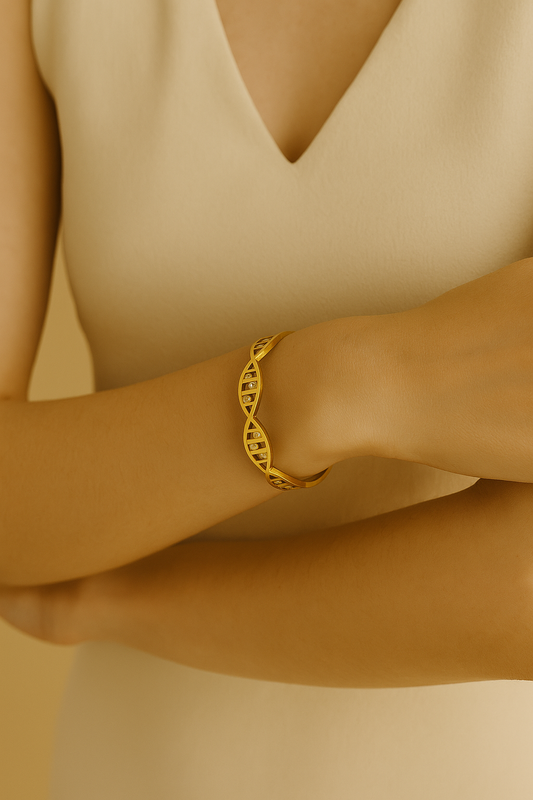 Golden cuff bracelet with geometric, DNA-inspired design